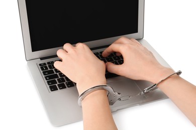 Woman in handcuffs typing on laptop against white background, closeup. Internet addiction