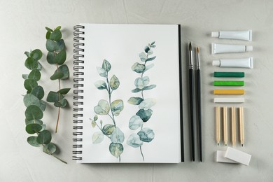 Flat lay composition with beautiful drawing of eucalyptus branches on white table