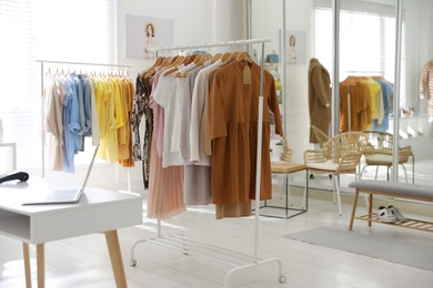 Stylish women's clothes on rack in modern boutique