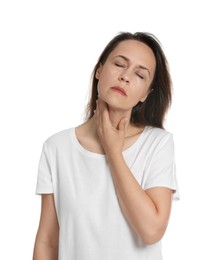 Mature woman doing thyroid self examination on white background