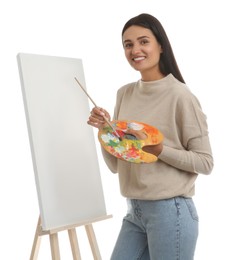 Young woman drawing on easel against white background