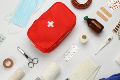 Flat lay composition with first aid kit on white background