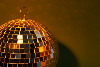 Shiny disco ball on color background, closeup. Space for text