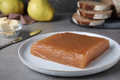 Delicious quince paste on grey table, closeup