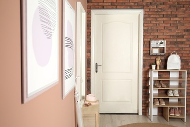 Photo of Modern hallway interior with white door and wooden furniture