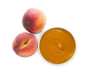 Peach puree in bowl and fresh fruits on white background, top view