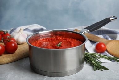 Delicious tomato sauce in pan on marble table