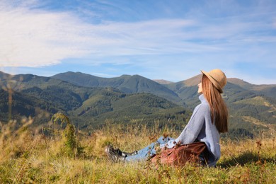 Photo of Young woman enjoying beautiful mountain landscape on sunny day