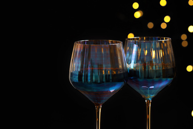Glasses of red wine against blurred lights, closeup
