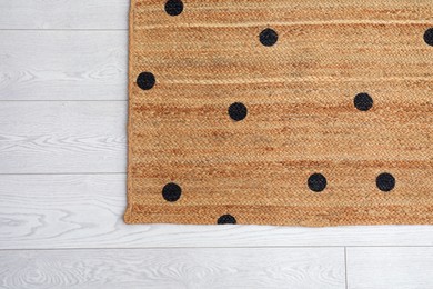 Stylish rug with dots on floor, top view