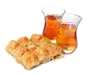 Delicious baklava with pistachios and hot tea on white background