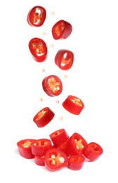 Pieces of ripe red chili peppers falling into heap on white background 