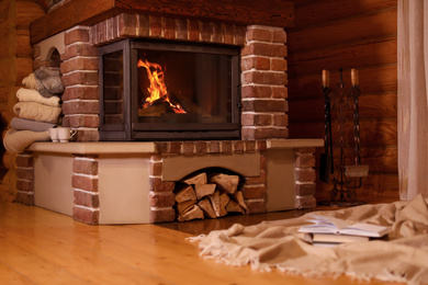 Fireplace with burning wood in room. Winter vacation