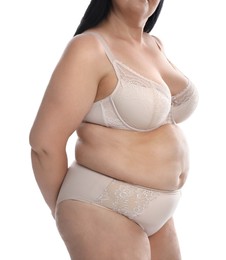 Overweight woman in beige underwear on white background, closeup. Plus-size model