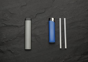 Disposable electronic smoking device near lighter and cigarettes on black background, flat lay