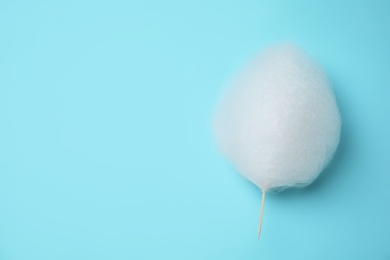 Photo of Sweet cotton candy on light blue background, top view. Space for text