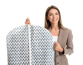 Young woman holding garment cover with clothes on white background. Dry-cleaning service