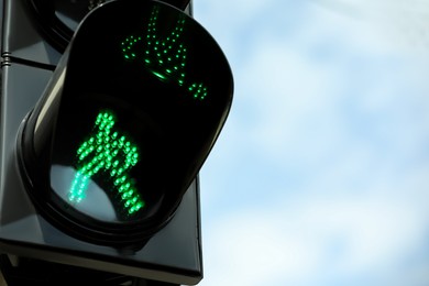 Closeup view of traffic light against blue sky. Space for text