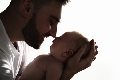 Father with his newborn baby on white background, closeup view
