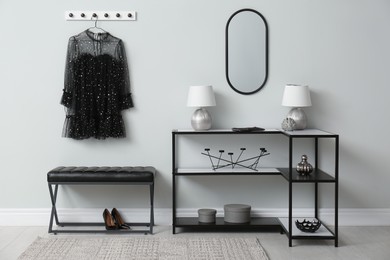 Photo of Modern hallway with stylish furniture, clothes and accessories. Interior design