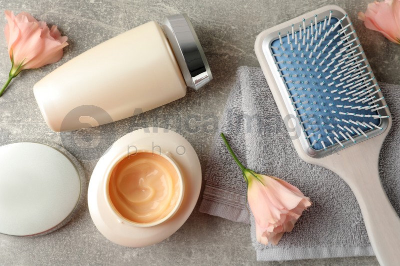 Flat lay composition with hair care cosmetic products on light grey table