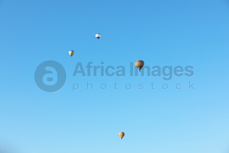 Colorful hot air balloons flying in blue sky