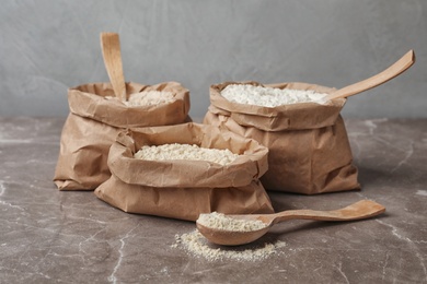 Paper bags with different types of flour on table
