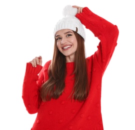 Happy young woman in hat and red sweater on white background. Winter season
