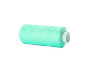 Spool of turquoise sewing thread isolated on white