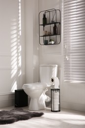 Modern toilet bowl in comfortable restroom. Interior design