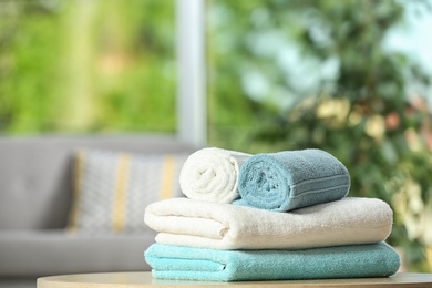 Clean soft terry towels on table indoors. Space for text