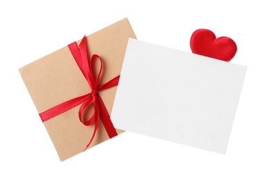 Blank card, envelope and red decorative heart on white background, top view. Valentine's Day celebration
