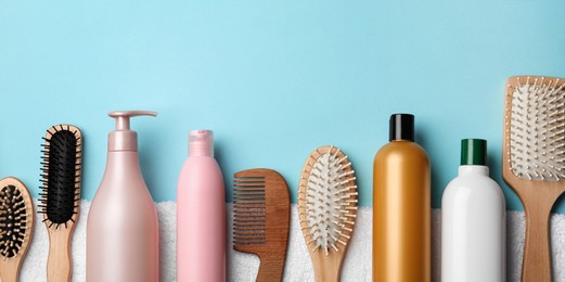 Set with hair cosmetic products and tools on light blue background, flat lay. Banner design