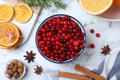 Flat lay composition with fresh ripe cranberries on white marble table