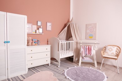 Baby room interior with stylish furniture and comfortable crib