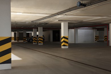 Car parking garage with warning stripes on columns