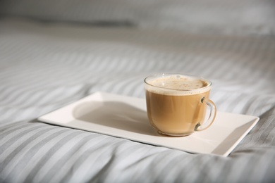 Tray with morning coffee on soft blanket. Space for text