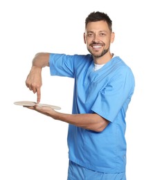 Handsome male orthopedist showing insole on white background