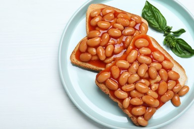 Toasts with delicious canned beans on white wooden table, top view