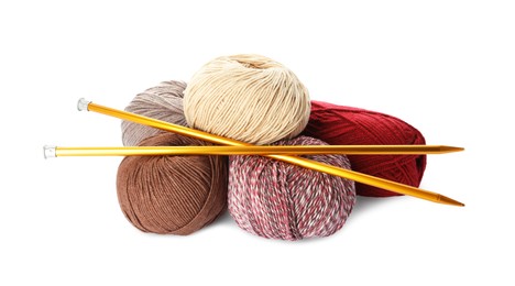 Different balls of woolen knitting yarns and needles on white background