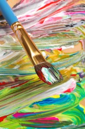 Abstract colorful acrylic paint and brush, closeup view