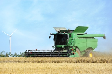 Modern combine harvester working in agricultural field