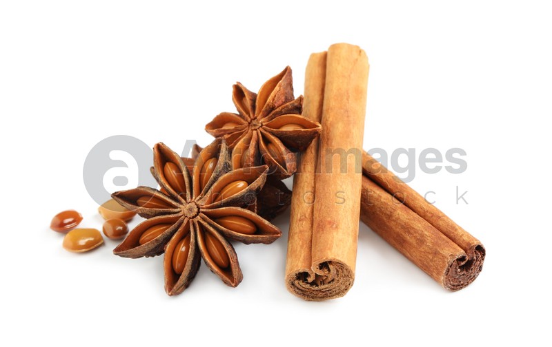 Dry anise stars and cinnamon sticks on white background