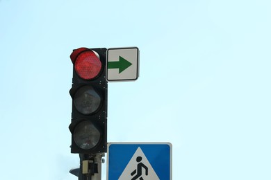 View of traffic light against blue sky, space for text