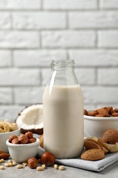 Vegan milk and different nuts on light table