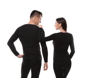 Couple wearing thermal underwear isolated on white, back view
