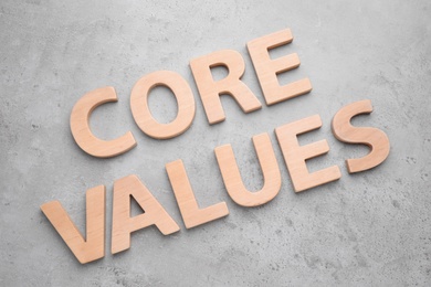 Phrase CORE VALUES made with wooden letters on grey background, flat lay