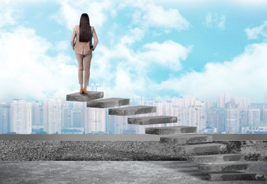 Woman standing on top of stairs and looking at cityscape. Way to success