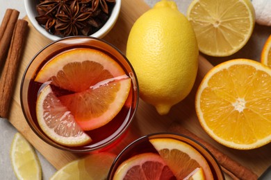 Aromatic punch drink and ingredients on table, flat lay