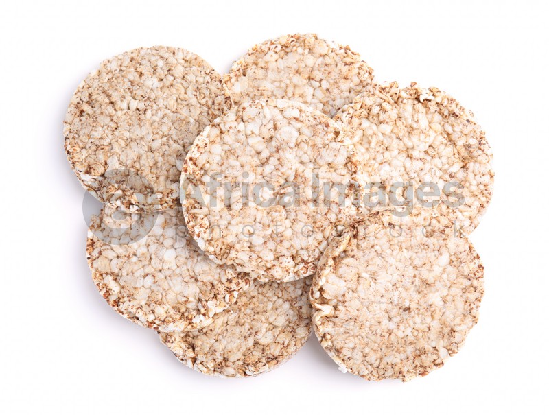 Many crunchy buckwheat cakes on white background, top view